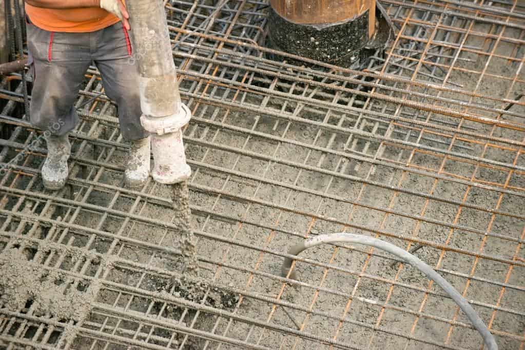 worker pouring concrete